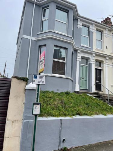 a house with two signs in front of it at Modern Luxury 3 bed house in Plymouth