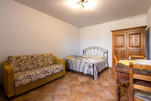 a living room with a couch and a table at Casa Ulmi con piscina in Uggiano la Chiesa