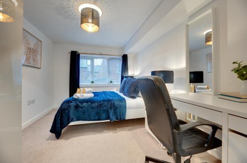 a bedroom with a bed and a desk and a window at Charltons Bonds Apartments 18 by Week2Week in Newcastle upon Tyne