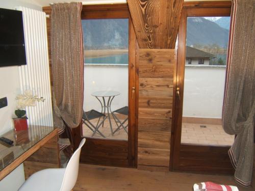 a room with a door with a view of a balcony at Hotel Berlinghera in Sorico