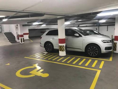 a parking garage with two cars parked in it at Cardeal Suites & Apartments in Faro