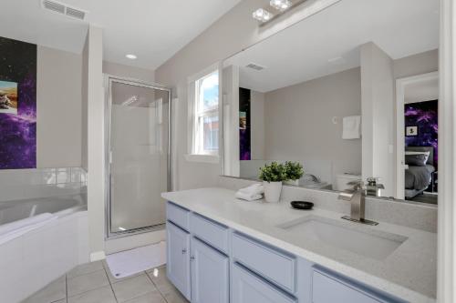 a white bathroom with a sink and a shower at Palm Daydreams in Davenport