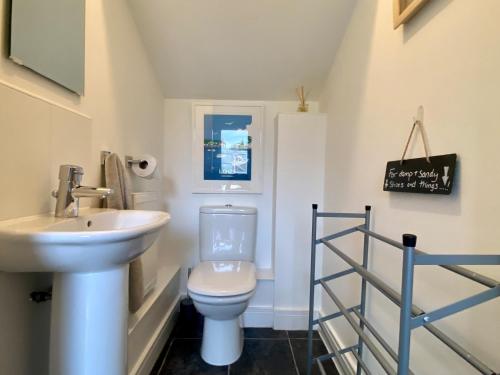 a small bathroom with a sink and a toilet at Meadow View in Truro