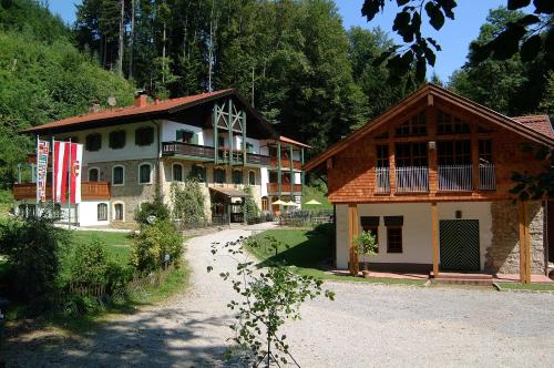 a large house in the middle of a road at Naturidyll Hotel Hammerschmiede in Anthering