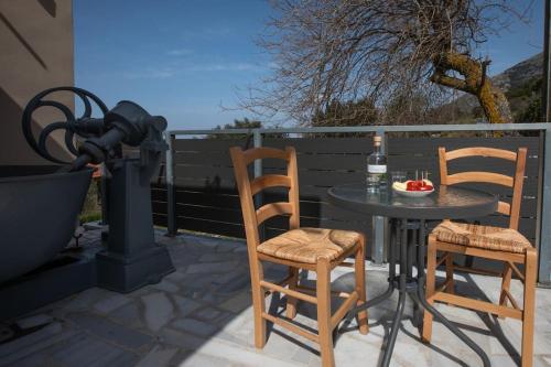a table and chairs on a patio with a camera at O Palaios Fournos tou Andrea (S) - Petrikata in Kardhakáta