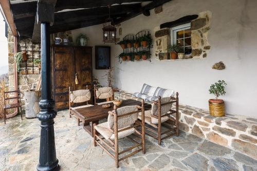 a room with a table and chairs in a building at Posada Casa Guadamillas in Bustancilles