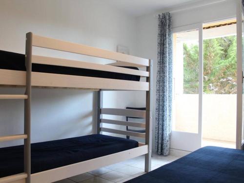 a bedroom with two bunk beds and a window at Maison Port-la-Nouvelle, 3 pièces, 7 personnes - FR-1-229C-673 in Port-la-Nouvelle