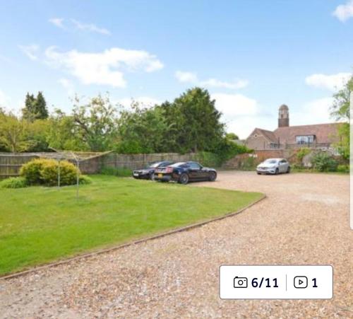 two cars parked in the driveway of a house at Acacia Villa in Dunstable