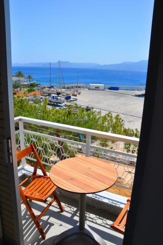 a table and chairs on a balcony with a view of the ocean at Nora Hotel in Sitia