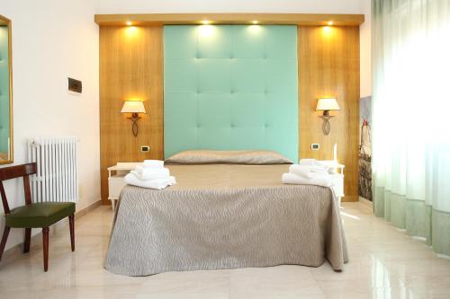 a bedroom with two beds with towels on them at Albergo Russo in Trapani