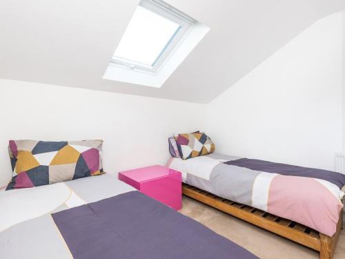 a bedroom with two beds and a window at Hayloft in Lincoln