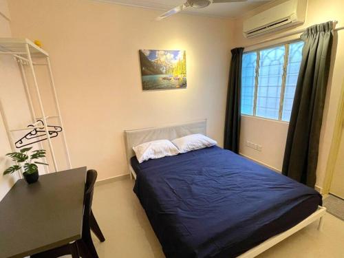 a bedroom with a bed and a table and a window at 6-12pax The Premium House - The Heart Of Sunway in Petaling Jaya