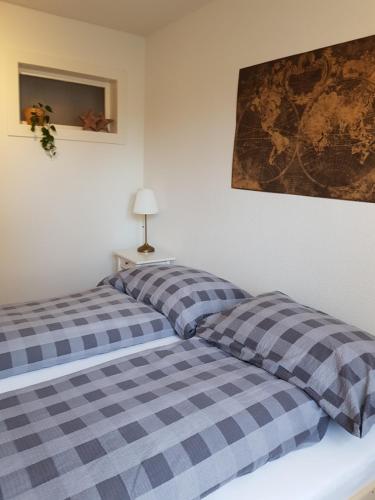 a bedroom with two beds and a map on the wall at Interlaken Apartments in Interlaken