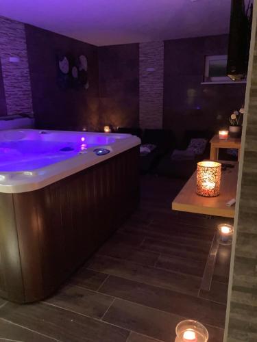 a bath tub with purple lighting in a room at Penzión Fonte in Radava