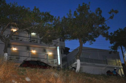 a building with a car parked in front of it at Nora Hotel in Sitia