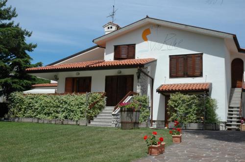 a white house with a cross on the roof at Villa Rilke Duino in Duino