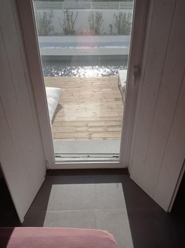 an open door leading to a patio with a deck at Casa Monda- Comporta in Carvalhal