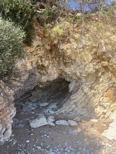 a cave on the side of a hill with rocks at Villa Delfini in Chrani