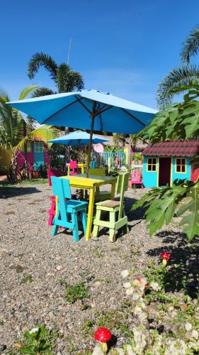 a table and chairs with an umbrella on the beach at Dunas Tatacoa in Villavieja