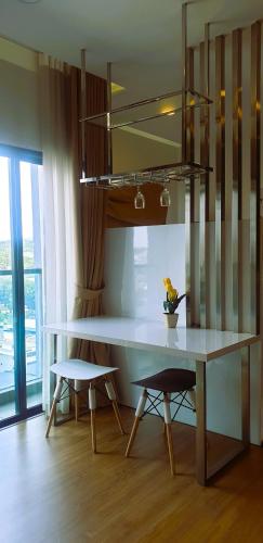 a dining table and two chairs in a room at Eshue Designer Suites @ Simfoni Towers in Cheras