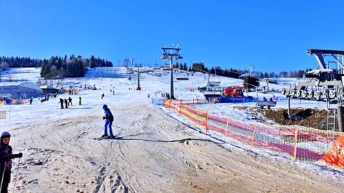 a group of people skiing on a ski slope at Apartament Lewinek in Lewin Kłodzki