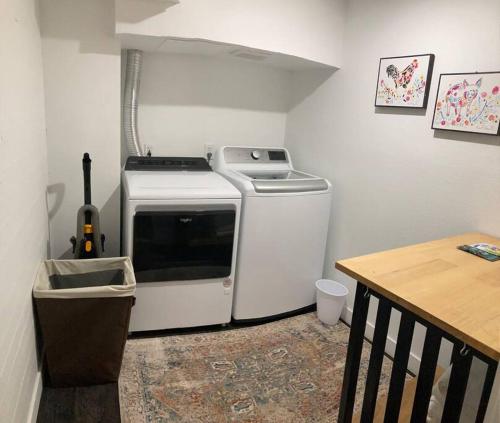 a small kitchen with a stove and a table at Centrally located, family and furry friendly fun! in Yakima