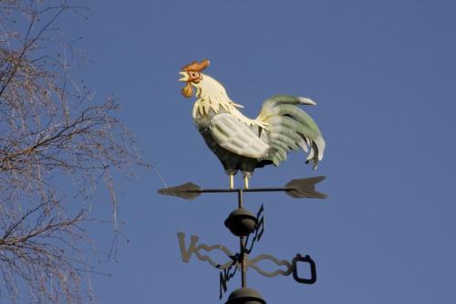 a statue of a rooster on top of a pole at Hem till Gården boutique hotel in Västerås