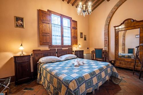 a bedroom with a bed with a towel on it at Hotel Villa Maya in Cascina