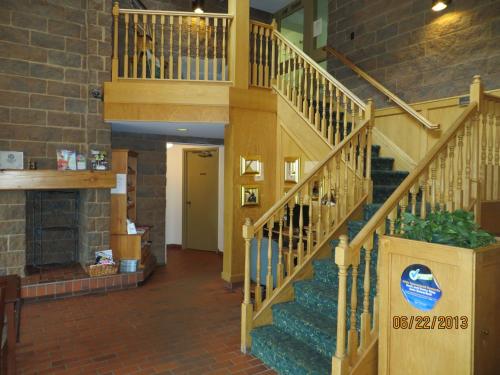 a stairway in a building with a wooden staircase at Super 8 by Wyndham Sudbury ON in Sudbury