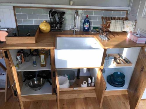 a kitchen counter with a sink in a kitchen at Aspen Leaves: The perfect farm retreat in Graffham