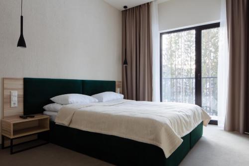 Postel nebo postele na pokoji v ubytování HVOYA Apart-Hotel & SPA