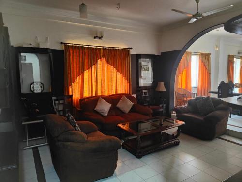 a living room with a couch and a table at Kapsstone HOMESTAY- Apartments &Rooms near APOLLO &SHANKARA NETHRALAYA HOSPITALS -Greams Road in Chennai