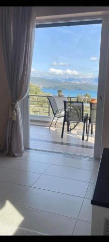 an open door to a balcony with a view of the ocean at Elina's Maisonette in Episkopos