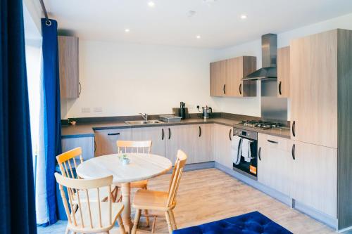 a kitchen with a table and chairs in a room at Oakley Place - Room C Deluxe Ensuite in Bristol