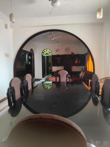 a dining room with a large table and chairs at Kapsstone HOMESTAY- Apartments &Rooms near APOLLO &SHANKARA NETHRALAYA HOSPITALS -Greams Road in Chennai