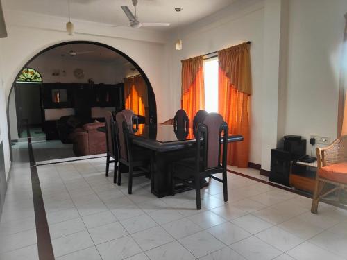 a dining room table and chairs in a living room at Kapsstone HOMESTAY- Apartments &Rooms near APOLLO &SHANKARA NETHRALAYA HOSPITALS -Greams Road in Chennai