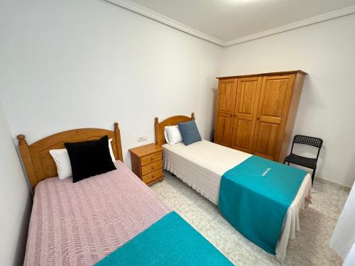En eller flere senge i et værelse på apartment arrecife beyond