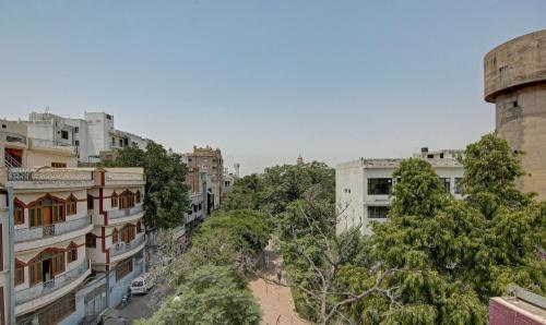 an aerial view of a city with buildings and trees at Raj Darbar - 10 Meter From Golden Temple in Amritsar