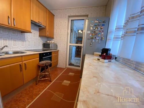a kitchen with a sink and a counter top at Moment Apartman Vrsac in Vršac
