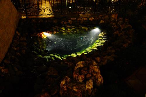 an overhead view of a pool of water at night at Pension La Fontana in Baia Mare