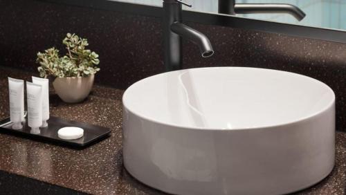 a white sink on a counter in a bathroom at Haworth Hotel at Hope College in Holland