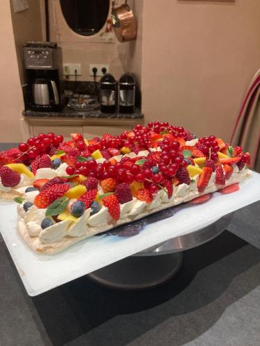 a cake with fruit on top of a table at B&B Vassy Etaule in Avallon