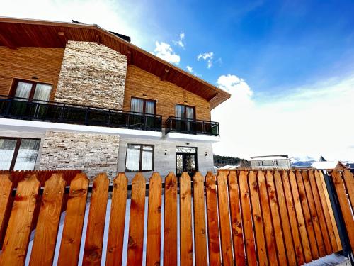 a wooden fence in front of a house at Villa Bayern in Bakuriani in Bakuriani