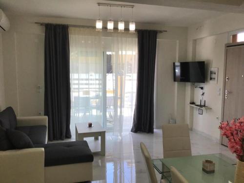 a living room with a couch and a table at Natalia House in Nikiti
