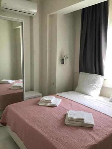a bedroom with a bed with two towels on it at Natalia House in Nikiti