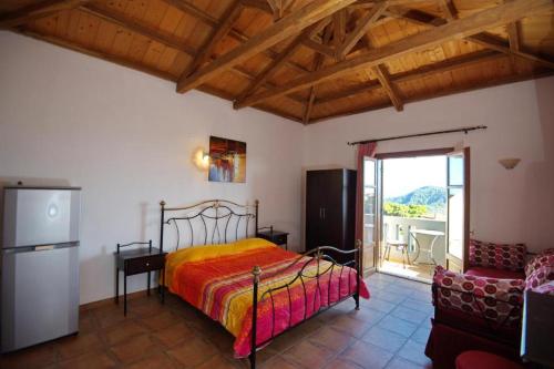 a bedroom with a bed and a refrigerator and a couch at Anatoli Residences in Alonnisos