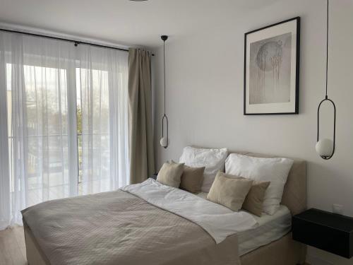 Ένα ή περισσότερα κρεβάτια σε δωμάτιο στο Apartament & Spa Dziwnów