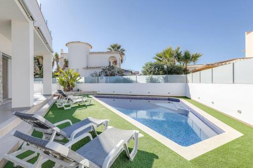a house with a swimming pool and lawnitures at VILLA LIMOEIRO - Beautiful new home nestled in the heart of Galé in Guia