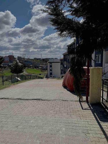 an empty parking lot with a tree and a building at Private Room in Istanbul #103 in Arnavutköy