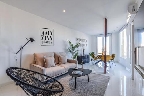 a living room with a couch and a table at AP Embajadores IX in Madrid